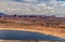 A few hundred small clouds on the horizon, above the slowing rising landscape of hills, Wahweap lookout, Page, AZ