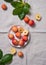 A few juicy mini apples in a white plate on a natural linen tablecloth