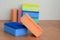 A few kitchen sponges lie on a wooden kitchen countertop. Colorful objects for washing dishes and cleaning in the house are ready