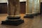 A few marble stone graphite granite supporting pillars in a hall with wooden timber floor