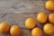 A few oranges, bright orange color on the old wooden background, brown color with a blurred background. Close-up.