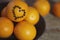 A few oranges with a heart aign made of close seeds in a gray bowl closeup on an old wooden backdround in brown with a blurred bac