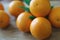 A few oranges with a heart aign made of close seeds in a gray bowl closeup on an old wooden backdround in brown with a blurred bac