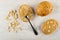 Few of peanut, spoon with paste on bread, bun, sandwich with peanut butter on table. Top view