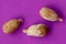 A few pieces of seed fresh red rambutan isolated on purple background. Top view of a seed of Nephelium lappaceum fruit. Rambutan