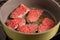 A few pieces of whole meat steak are chewed in a frying pan. The process of cooking meat.