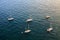 Few yachts are standing on the anchor, aerial view of sea surface