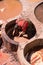 Fez, Morocco - March 9, 2018: A man working inside a stone vessel with leathers in a traditional tannery in the city of Fez,