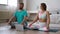 FHD footage - couple meditating at home in bedroom with online yoga tutorial.