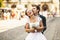 Fiance bites bride\'s ear holding her in his arms on the street