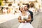 Fiance bites bride\'s ear holding her in his arms on the street