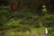 Fiancee in white dress standing alone in green field on Sao Miguel island, Azores