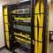 fiber optic cables plugged in network switch panel inside data center