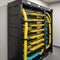 fiber optic cables plugged in network switch panel inside data center,