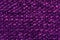 fiber texture polyester close-up. violet fleecy background. shaggy surface. fine grain felt red fabric