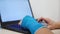 Fiberglass cast hand uses laptop