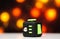 Fidget cube anti stress toy. Detail of finger play toy used for relax. Gadget placed on colorful bokeh background