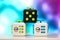 Fidget cube anti stress toy. Detail of finger play toy used for relax. Gadget placed on colorful bokeh background
