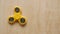 Fidget spinner toy rotates on wooden background