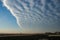 Field of altocumulus clouds with a sharp edge is invading the sky over Transylvania, Romania.
