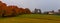 Field with barn on foggy morning