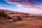 Field and Barn with Pink Clouds and Blue Sky