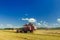 Field combine harvester elevator to upload cereal into tractor