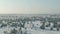 The field covered with snow in a winter season. Aerial view: Winter landscape countryside, forest, field. Winter