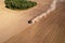 Field cultivating, aerial view. Tractor with disk harrow on plowed. Arable land ploughed and soil Tillage.