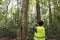 Field ecologist taking measures carbon in forests and track greenhouse gas emissions for monitoring biodiversity and forest