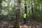 Field ecologist taking measures carbon in forests and track greenhouse gas emissions for monitoring biodiversity and forest