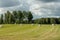 Field with harvested spools of hay