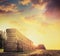 Field with hay or straw bales on background of beautiful sunset sky