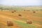 Field with haystacks. Russian open spaces. Dry grass twisted into stacks