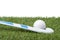 Field hockey stick and ball on the green field. Professional sport concept