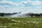 Field irrigation system with water sprinklers working on farm field