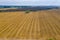 a field lie numerous bales of straw