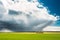 Field Or Meadow Landscape With Green Grass Under Scenic Spring Blue Dramatic Sky With White Fluffy Clouds