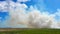 field and meadow in smoke clouds