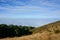 Field on mountain landscape , mist and blue sky