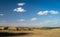 Field plowed after harvesting. Summer landscape with blue sky