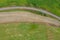 The field is plowed by a tractor near the railway. Sowed green manure in a field near the village.