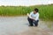 Field researcher biologist examines soil sample in vitro