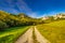 A field road through the valley of mountain landscape with rocky