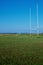 Field with tall goal posts for Irish National sports on green grass against clear blue sky. Rugby, hurling, camogie and Gaelic