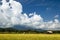 Field in Thailand with bamboo building and big sky in Chiang Mai