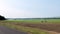 Field watered by automated irrigation pivot sprinkler system. Hand held.