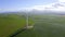 Field, wind turbines and green energy with drone, power supply and sustainability for environment. Electrical
