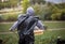 Field worker running with basket in plastic garbage bag as a raincoat in strawberry field