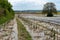 Fields with asparagus beds covered in black foil and a wonderful hill and forest landscape behind